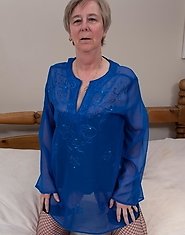 Naughty mom playing alone on her bed